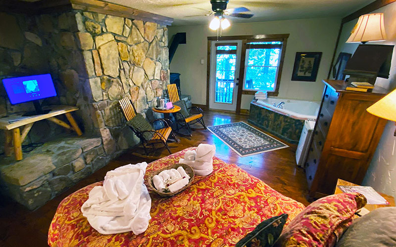 fieldstone room with rock wall and television