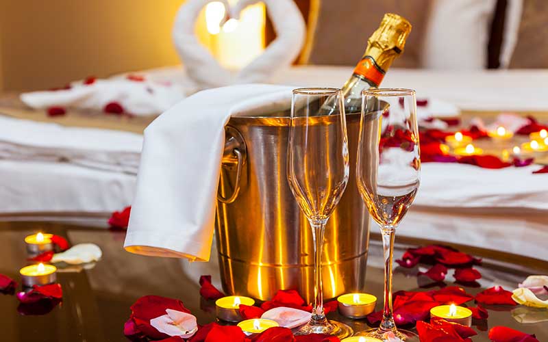 rose petal, candles, and champagne package